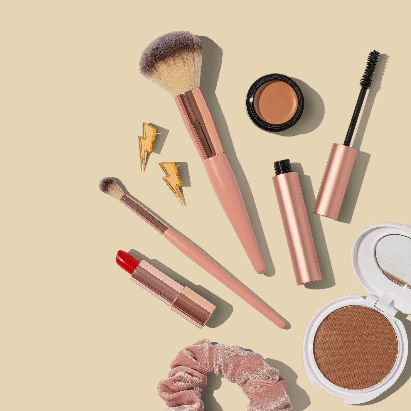 Makeup brushes, lipstick and cosmetics flat lay